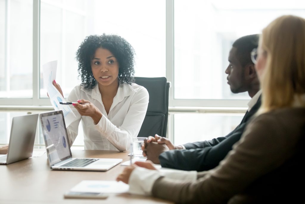 Proposal team reviewing a response together around a conference table