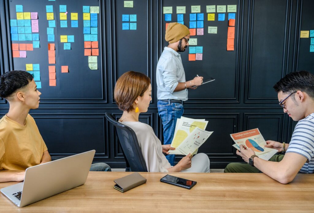 Team planning at a wall of sticky notes in a meeting room
