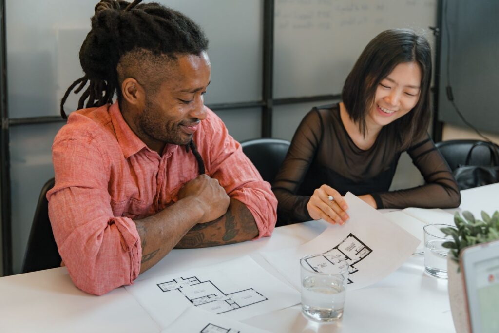 Two business owners reviewing paperwork together at a table