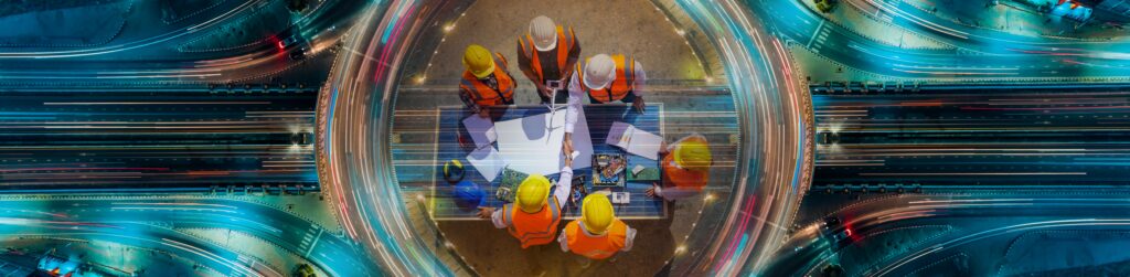 Overhead view of a construction team reviewing plans